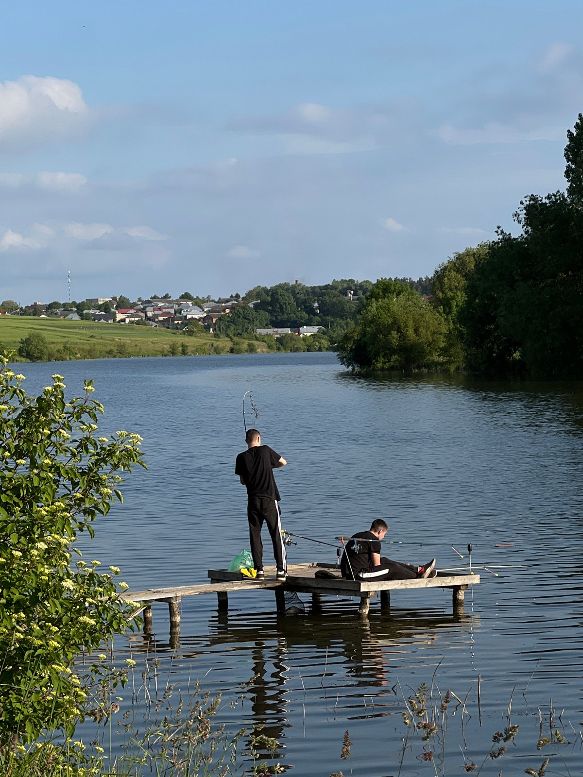 Two fishermen enjoy peaceful afternoon at Bazaryntsi lake