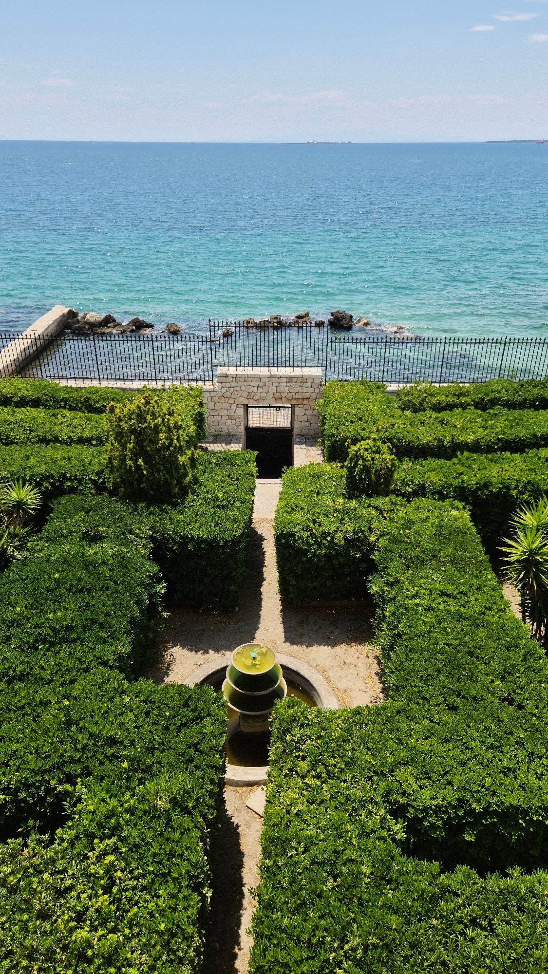 Taranto's Aragonese Castle and waterfront on a July morning