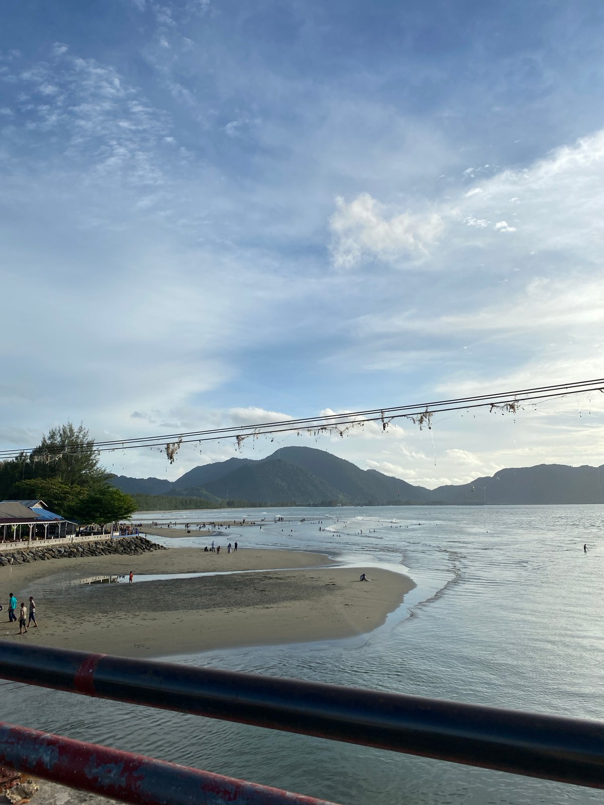Banda Aceh waterfront: coastal promenade, bridge traffic, and boats