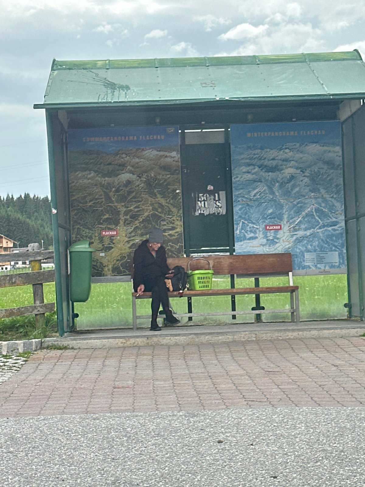 Bus stop and countryside glimpses in overcast Flachau