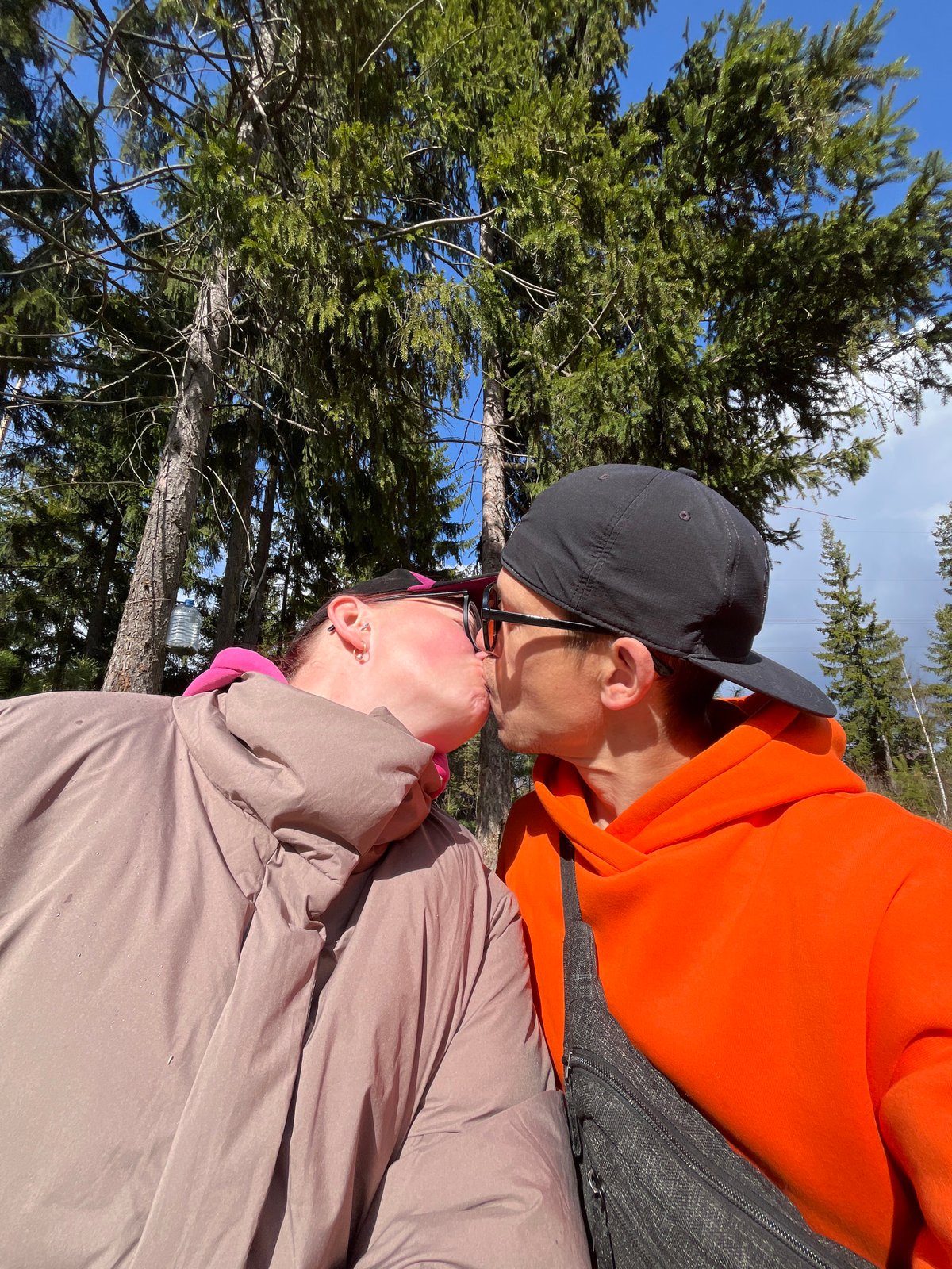 Couple shares intimate moment in Chaikovsky pine forest