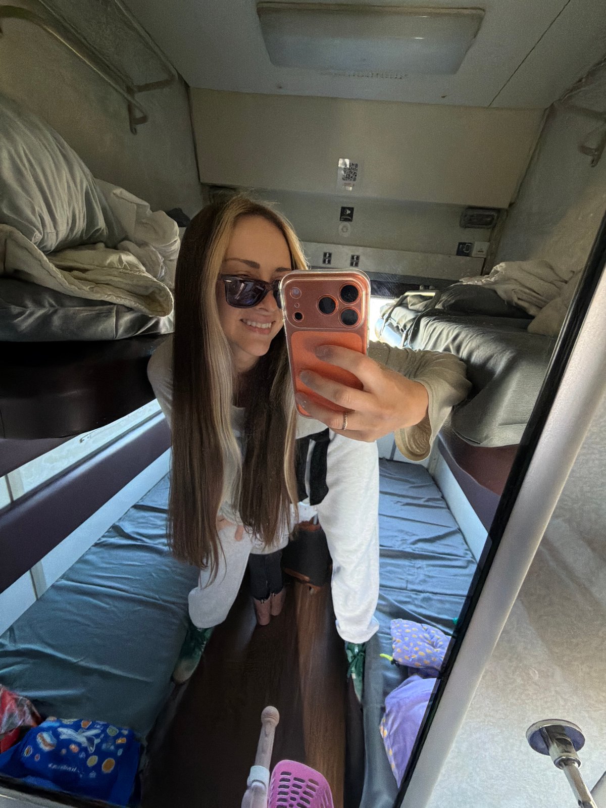 Woman takes mirror selfie in Russian train compartment