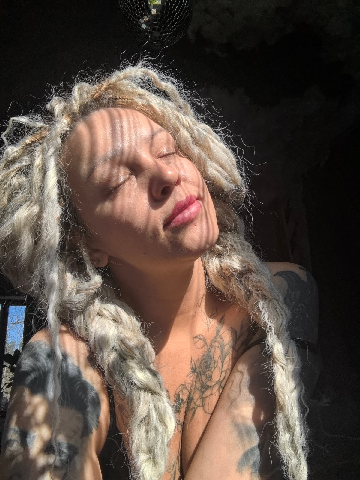 Woman with dreadlocks photographed indoors in Noviy, Russia