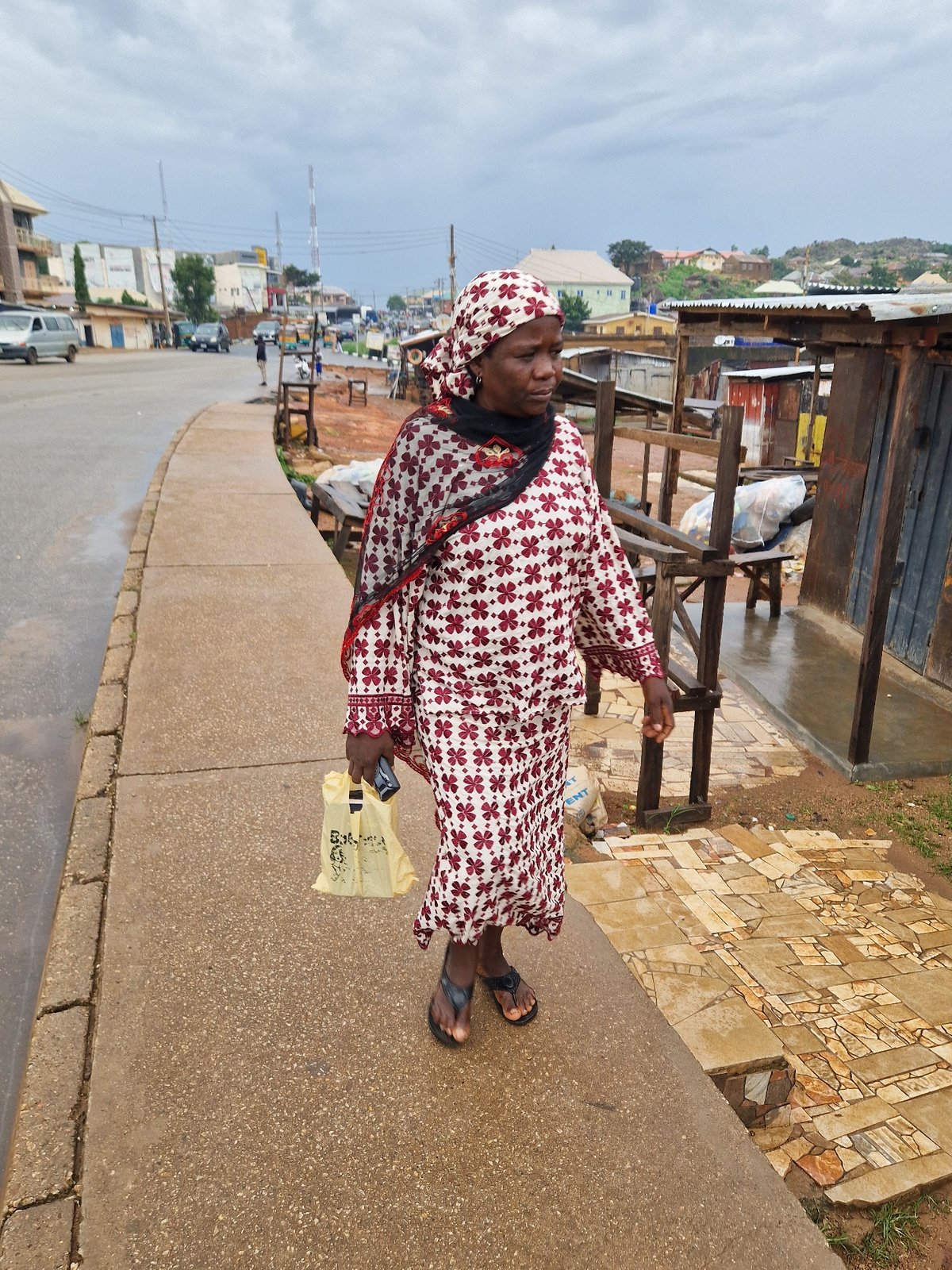 Wet morning foot traffic across two Jos neighborhoods