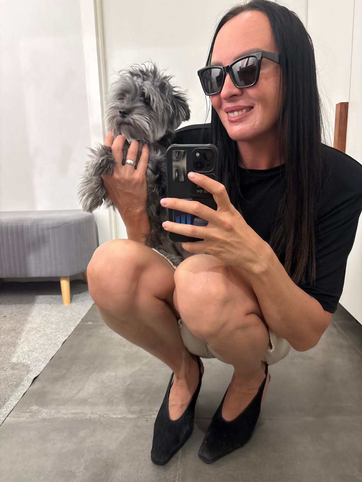 Woman takes selfies with gray dog in Chaikovsky