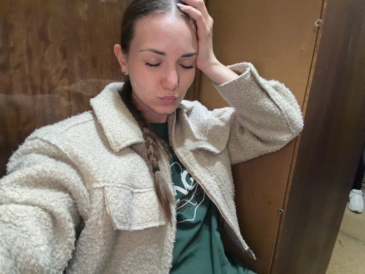 Woman browses traditional Bulgarian folk costumes in Sofia shop
