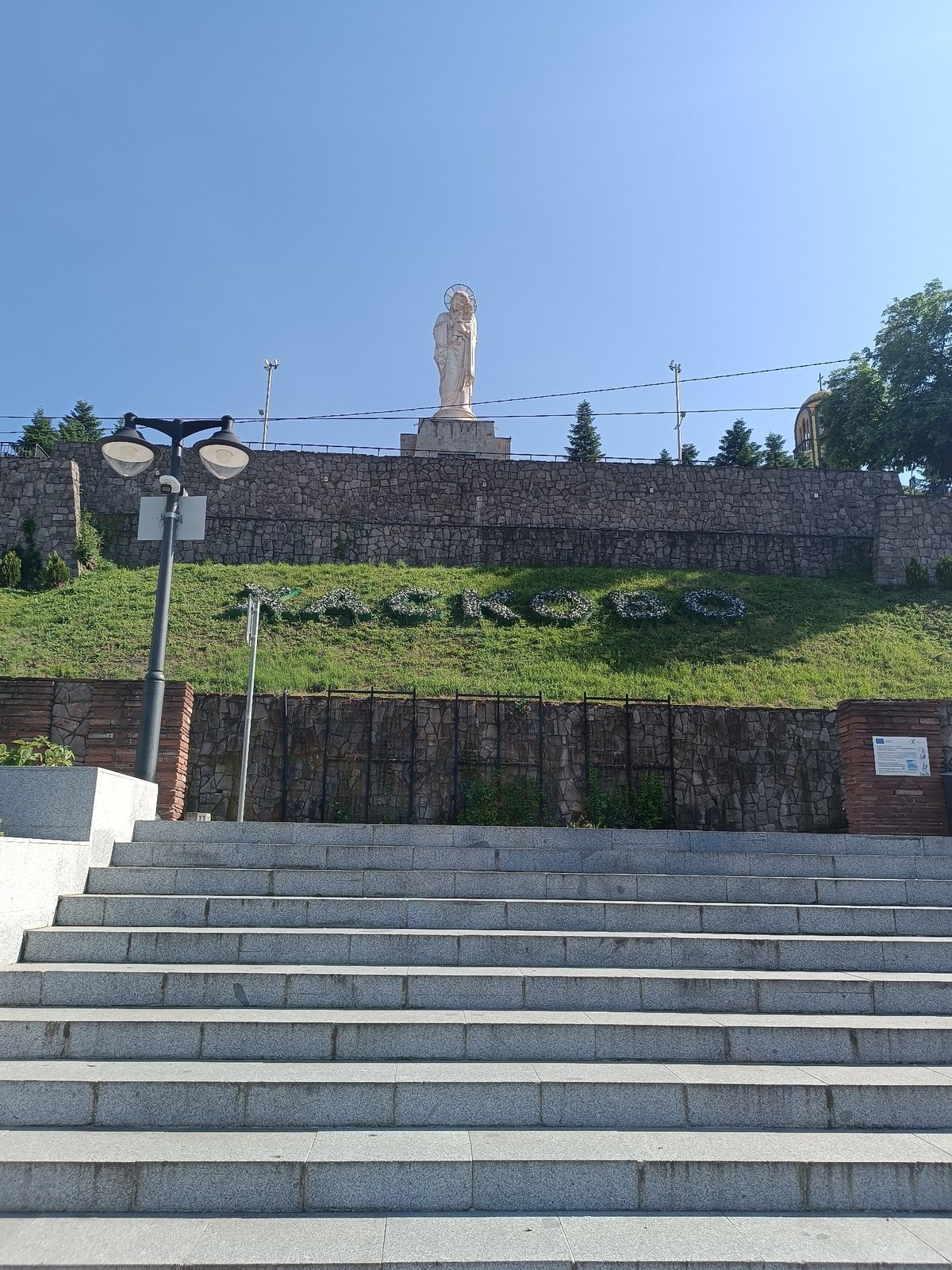 Stone stairway to statue monument documented by witness