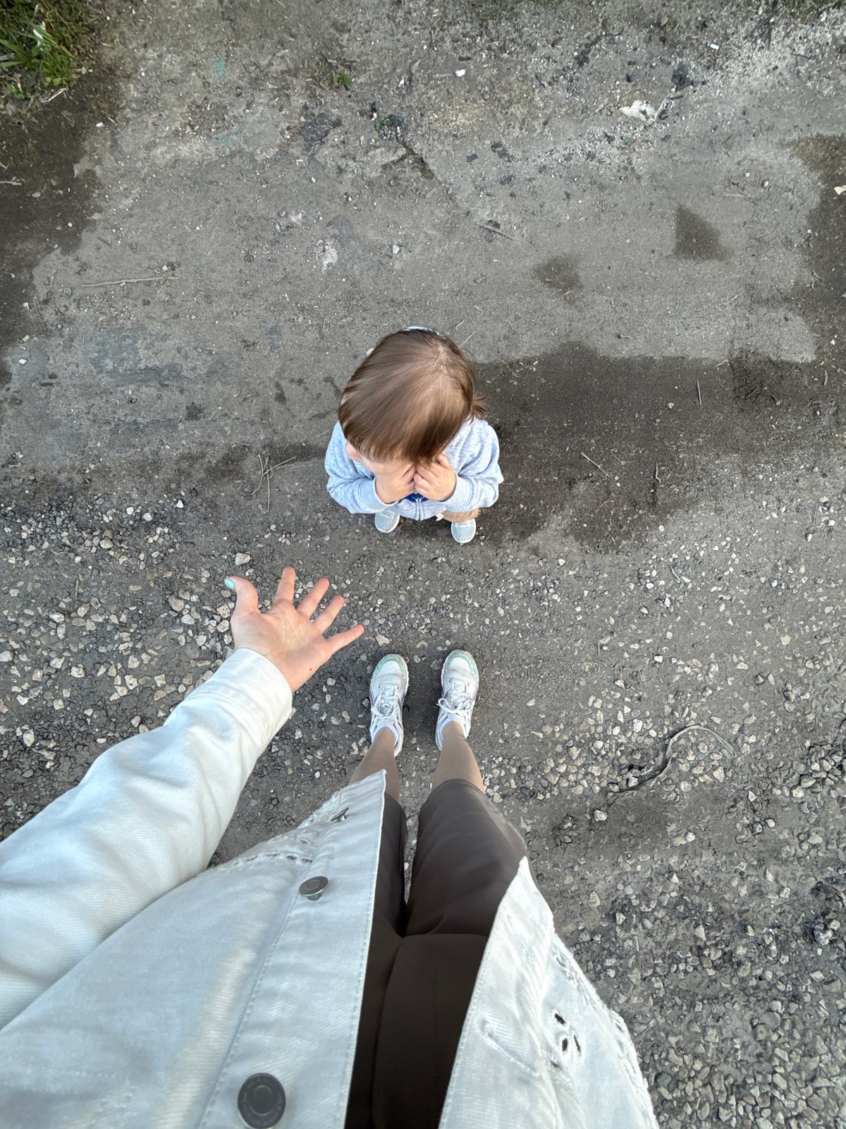 Toddler plays with dandelions near Moscow garage cooperative