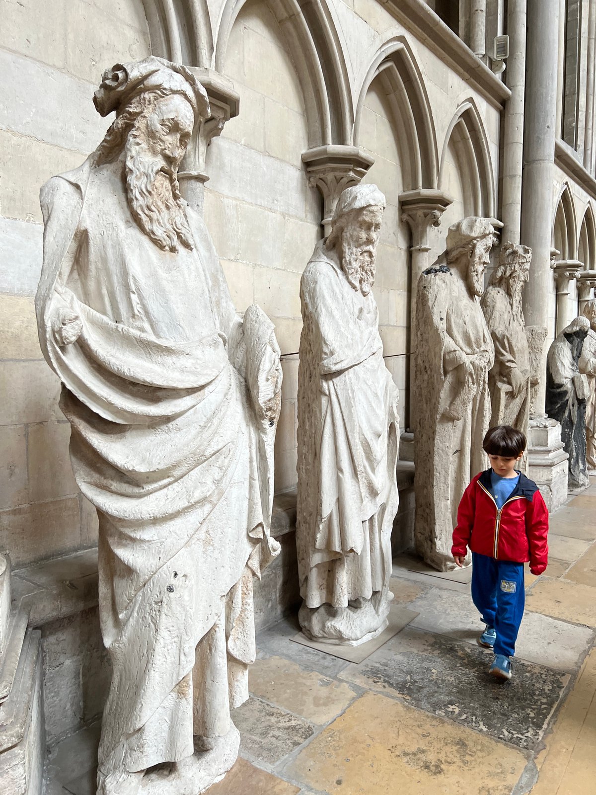 Boy in colorful jacket spotted inside historic stone cathedral