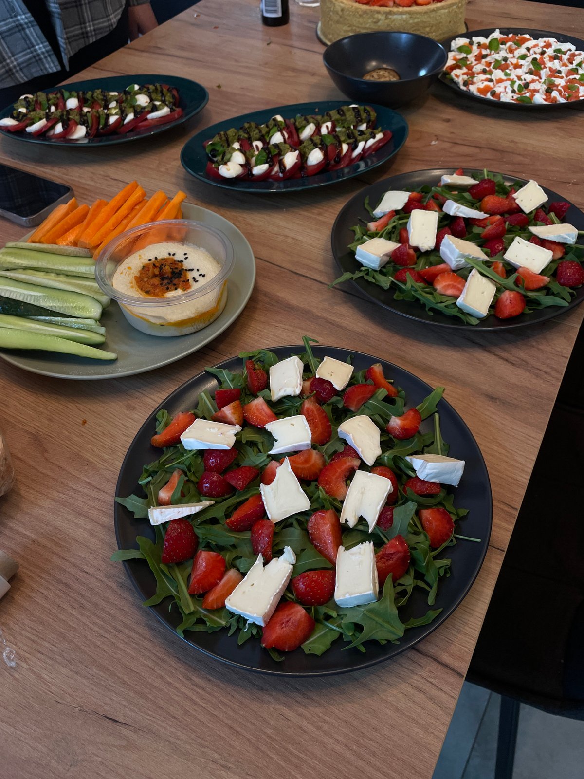Outdoor dining experience with appetizers and ceramic art documented