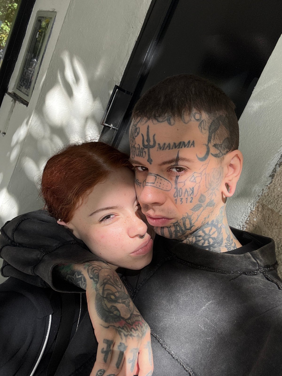 Couple embraces in sunlit Buenos Aires courtyard