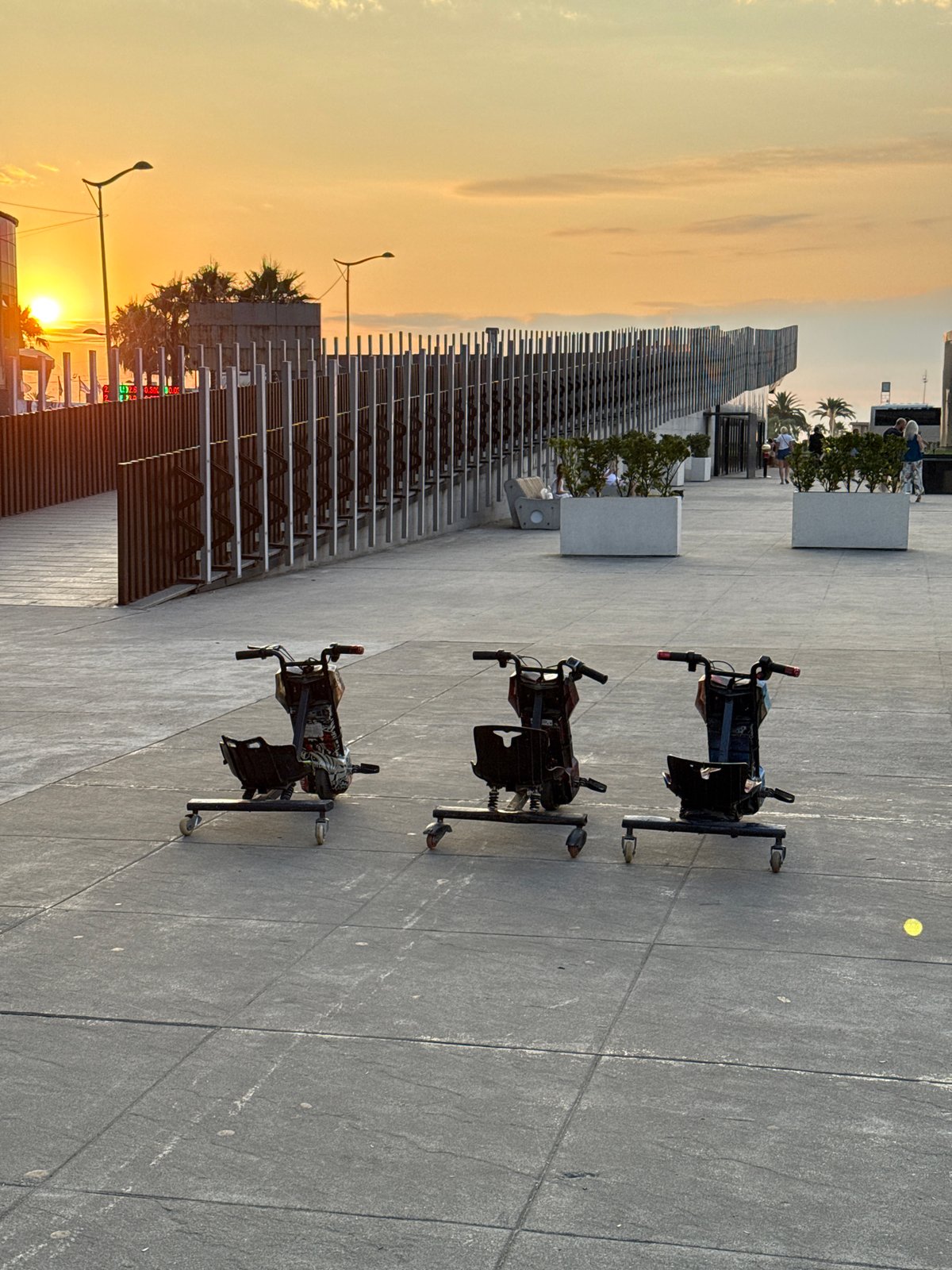 Drift trikes and fountains at a city plaza around sunset