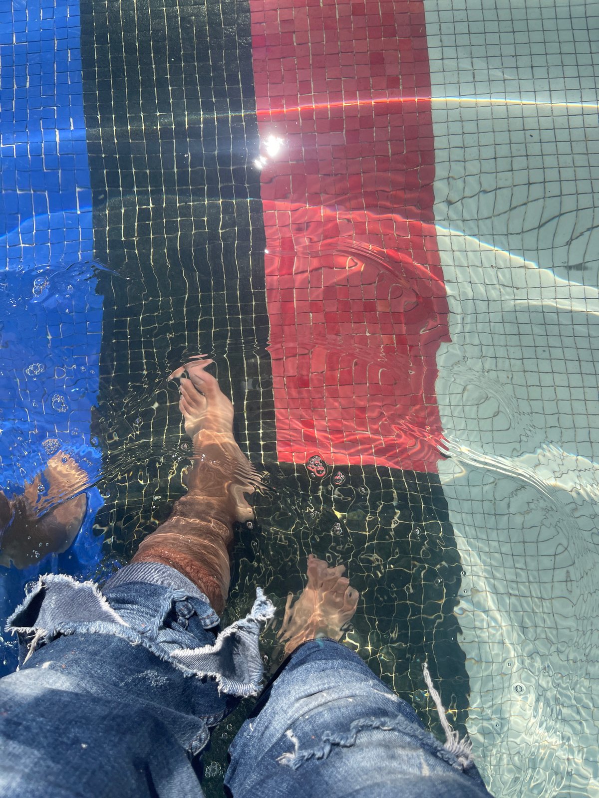 Wading through La Défense's colorful fountain on a sunny morning