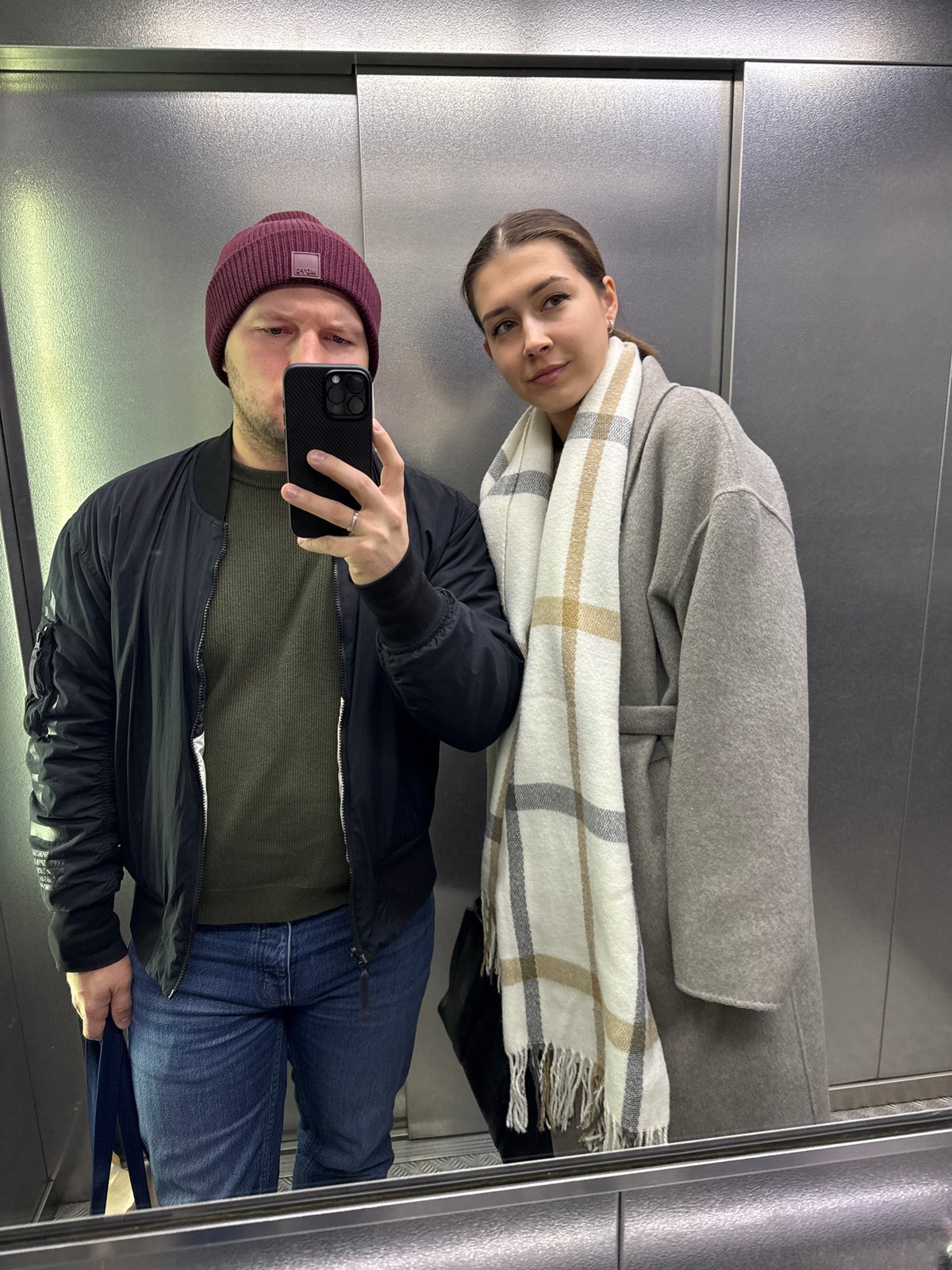 Two people caught in elevator reflection in Krasnoyarsk