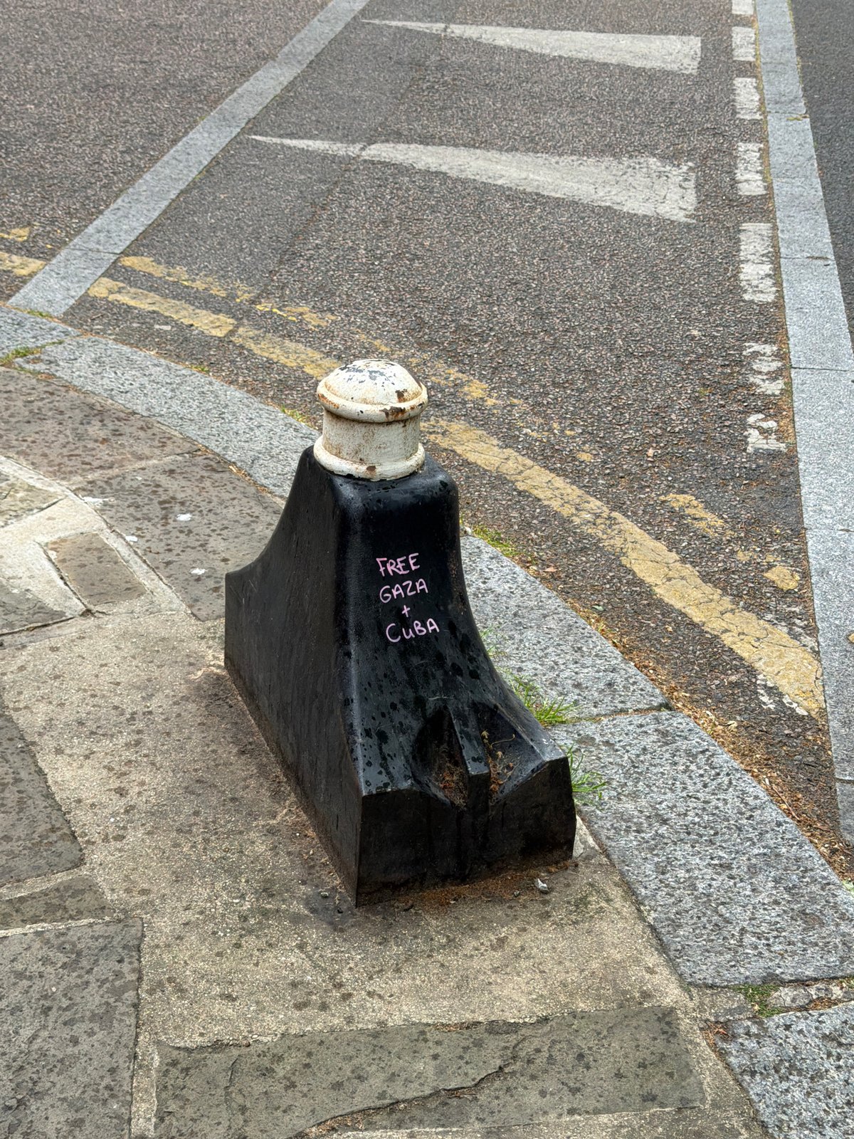 London street bollard with graffiti documented by witness