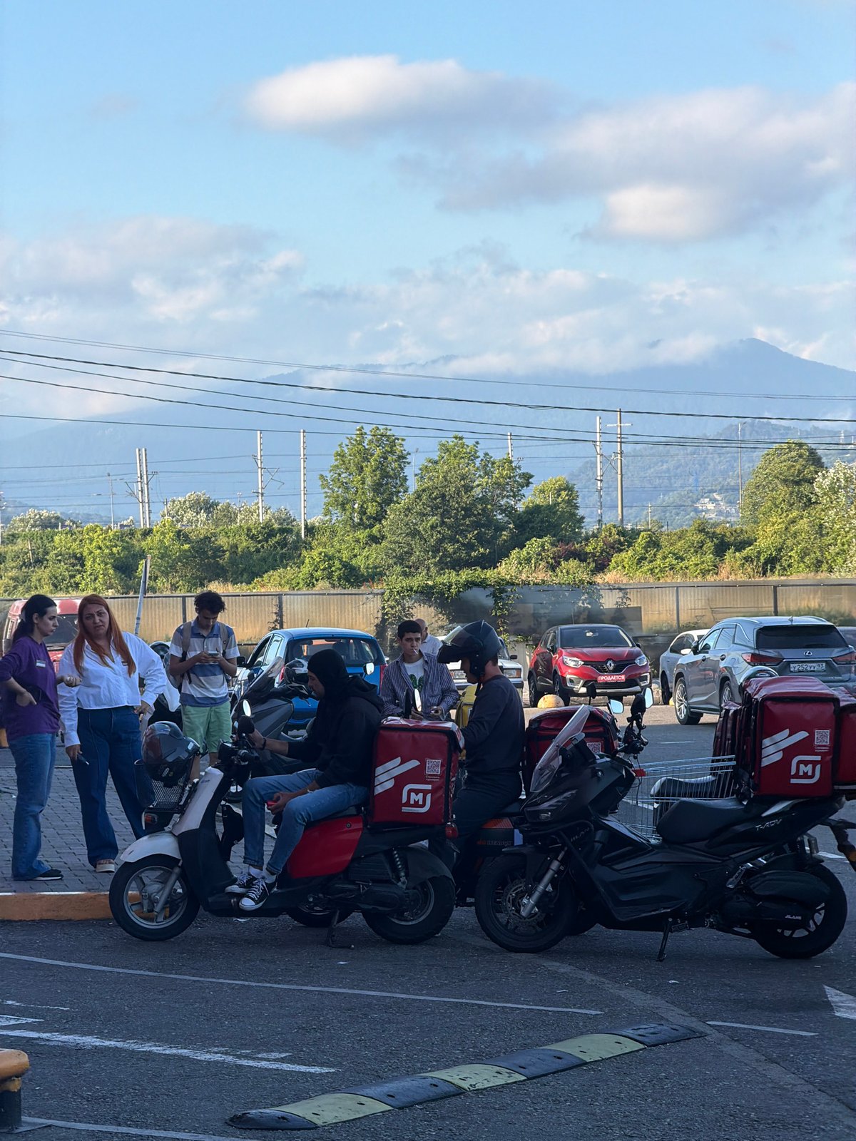 Afternoon activity around a Sirius, Russia parking lot and walkways