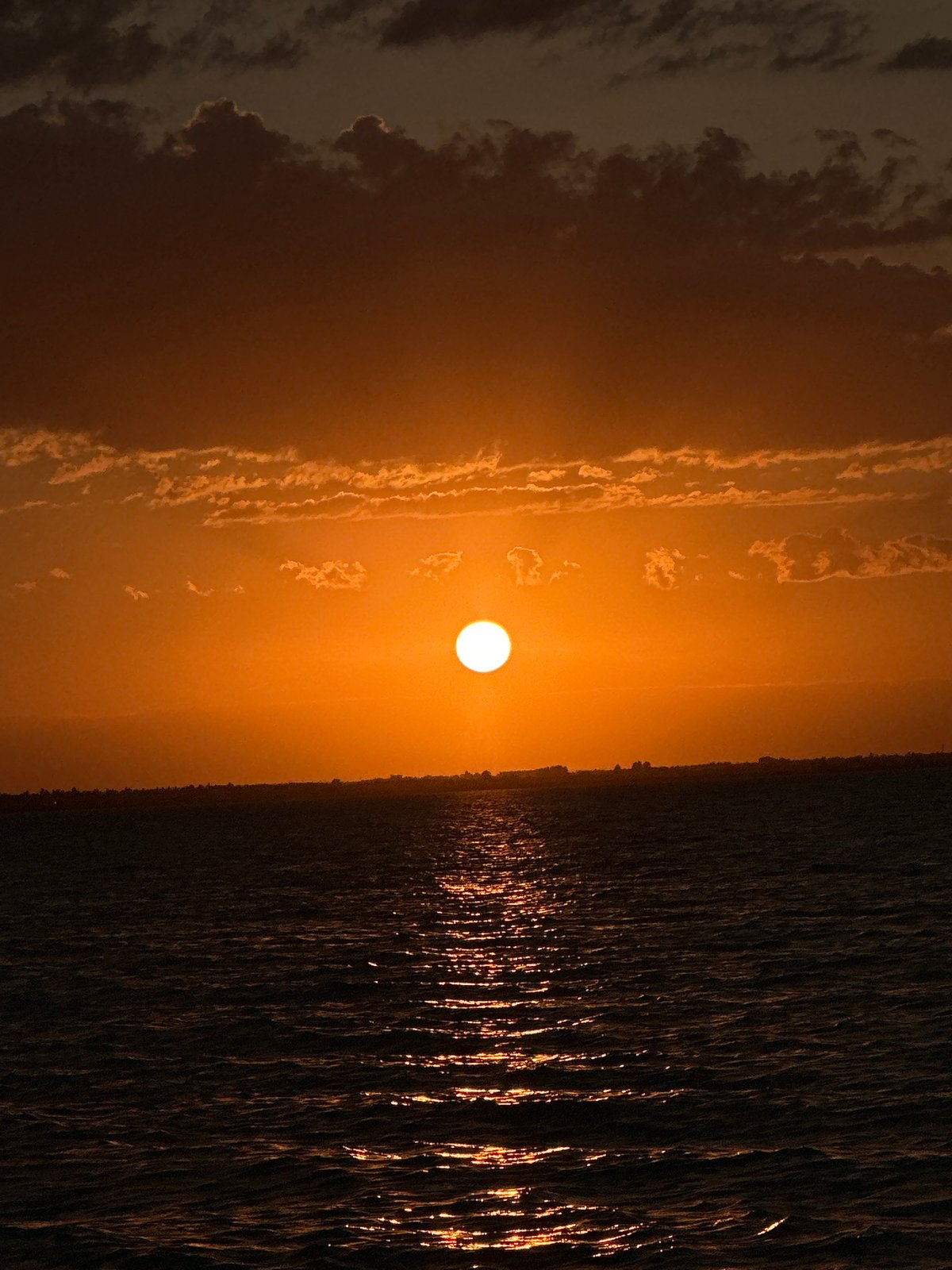Vivid orange sunset over a Kokshetau waterway