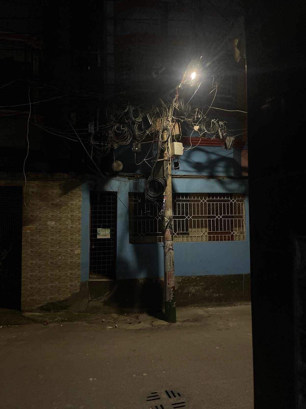 Nighttime street scenes documented in Dhaka alleyways