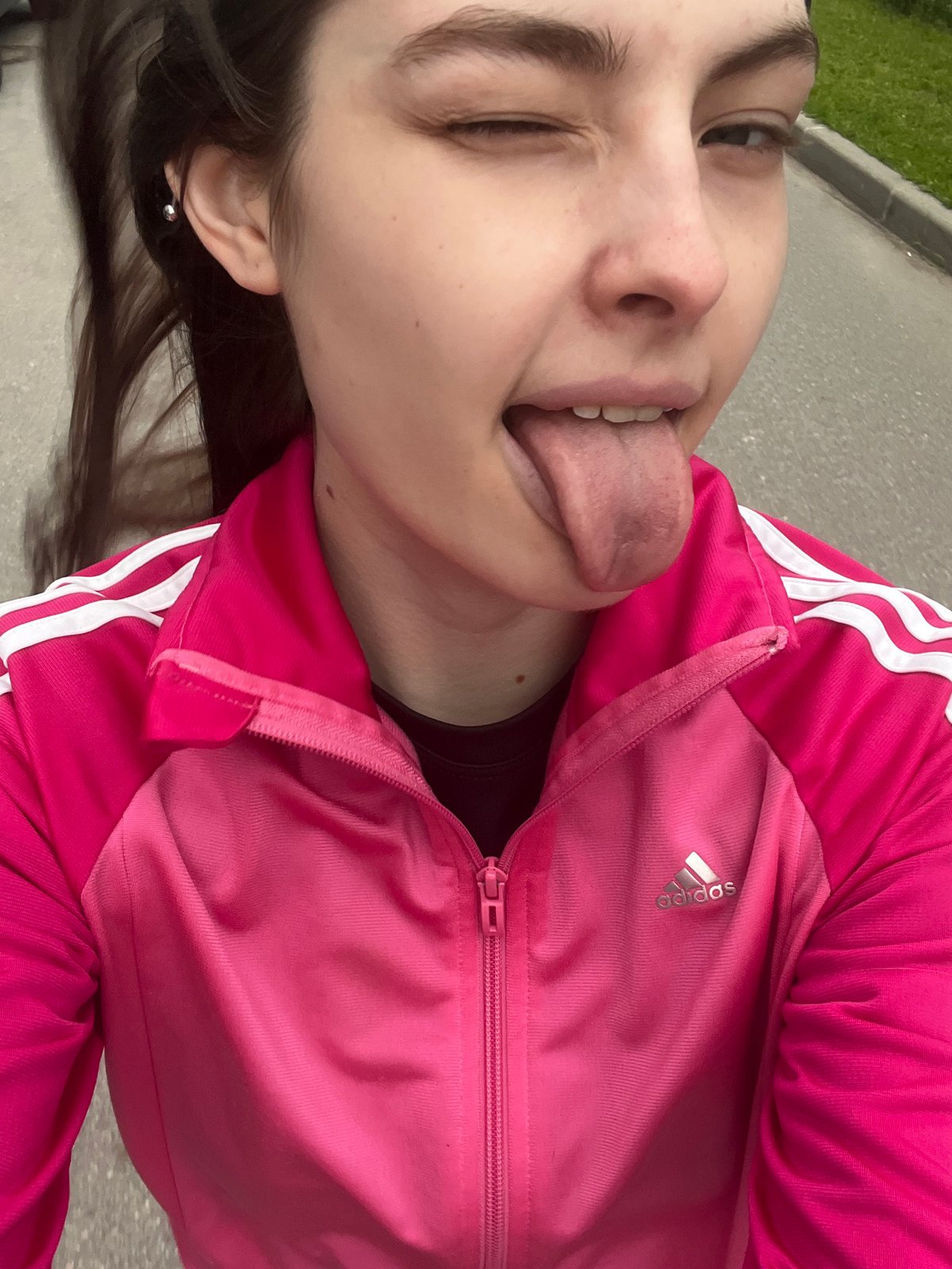 Woman in pink Adidas tracksuit takes selfies around Saint Petersburg