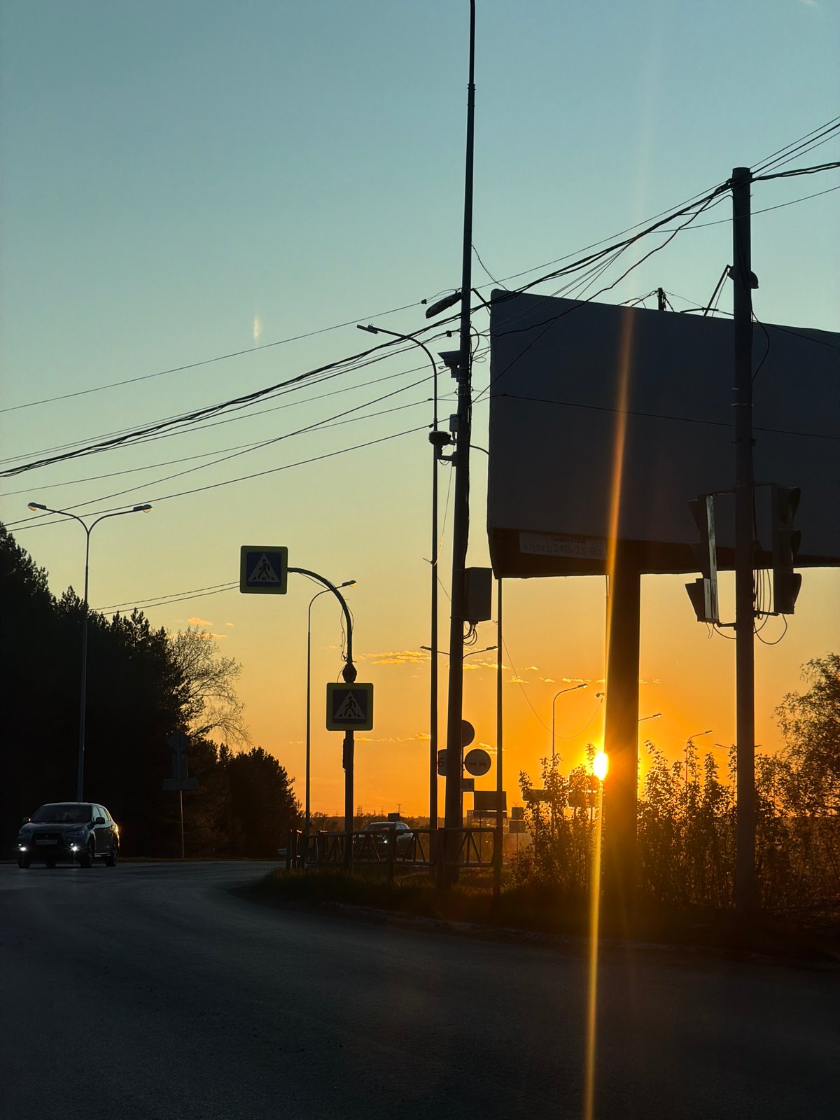 Sunset observed in Chaikovsky, Russia with silhouetted infrastructure
