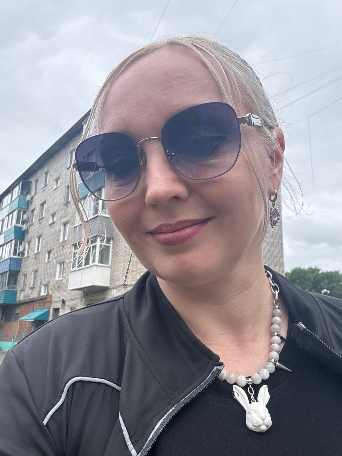 Selfie moment outside a brick apartment block in Komsomolsk-on-Amur