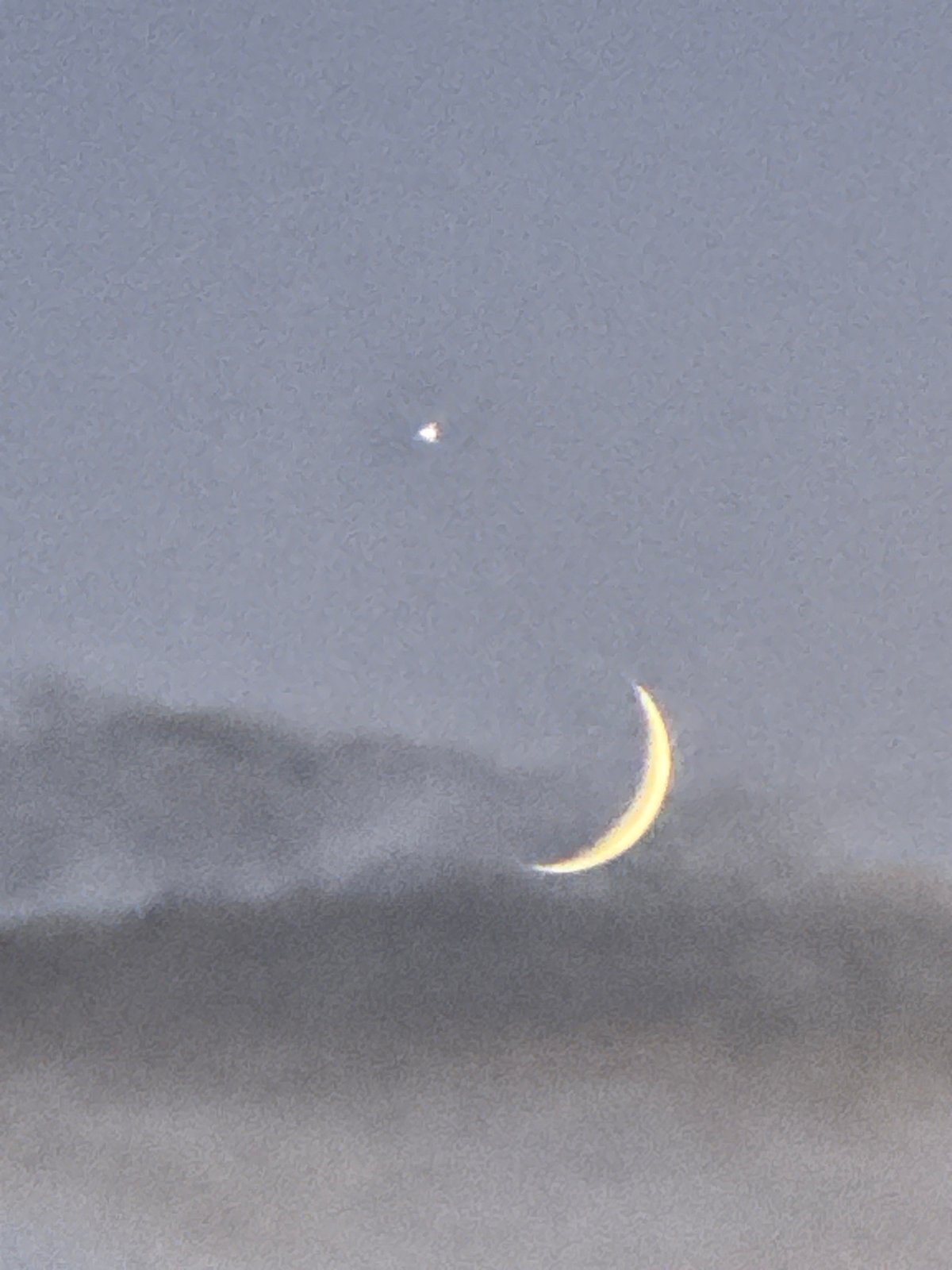 Crescent moon and bright planet at dusk over Bischheim