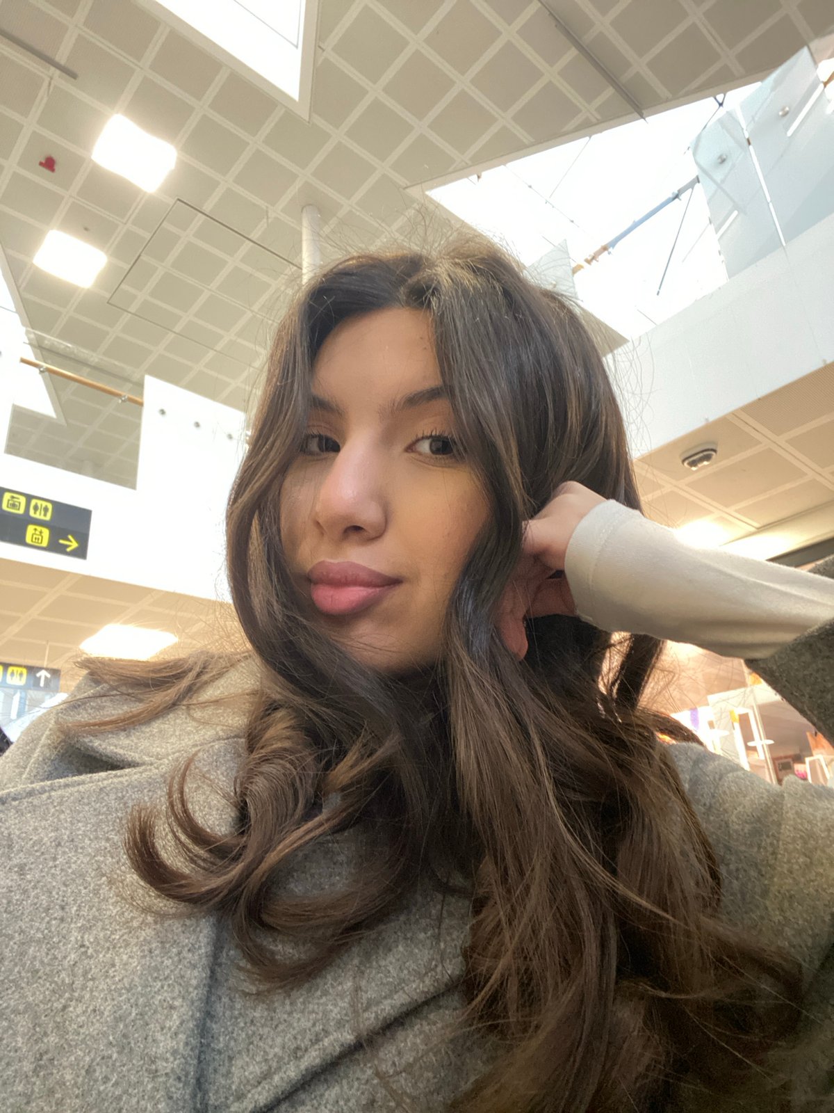 Woman takes early morning selfies at Uppsala Central Station