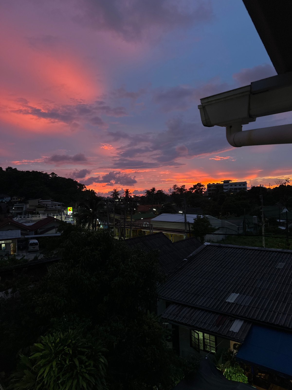 Karon sunset watched from a rooftop, one odd lighter shot