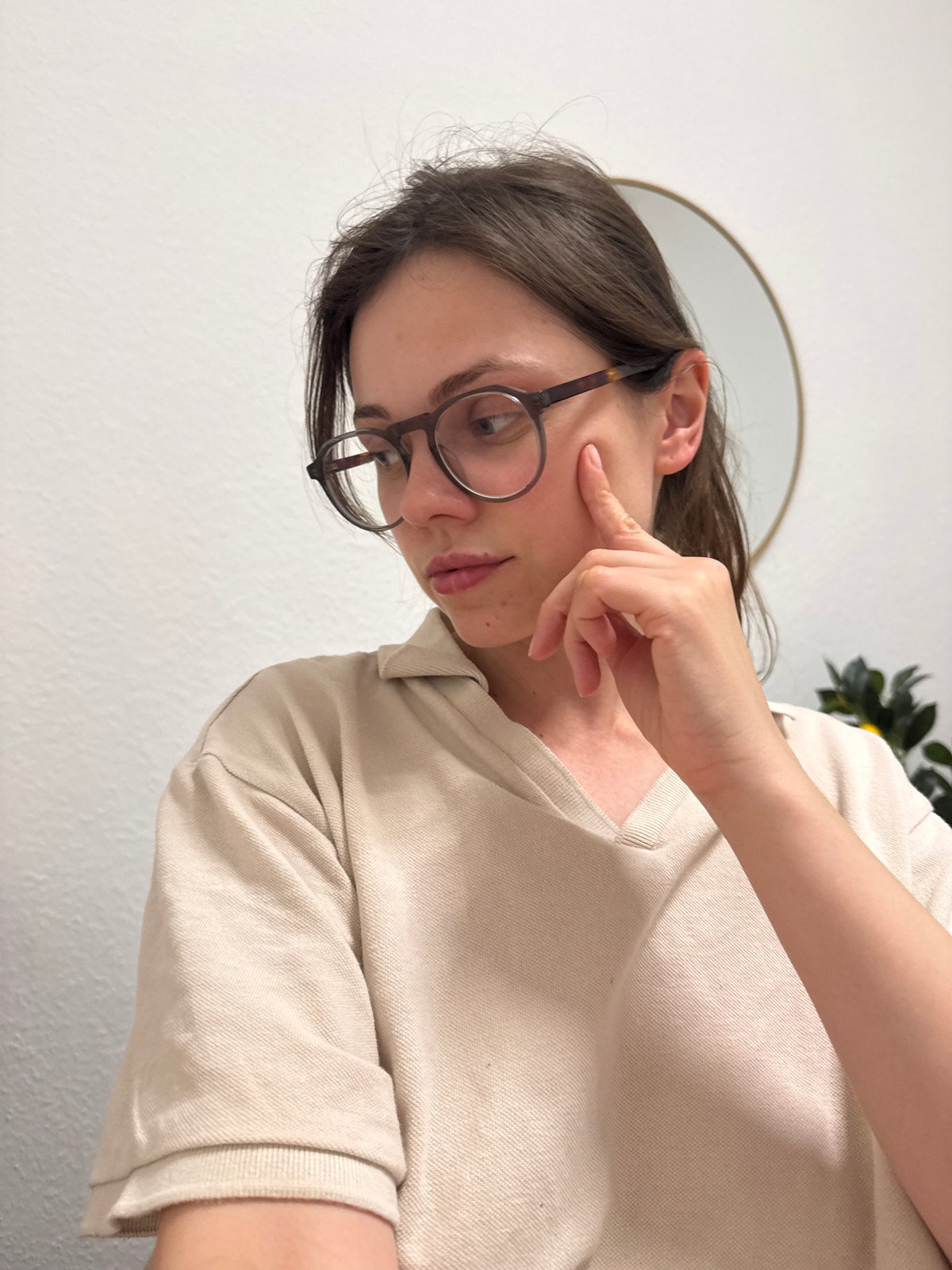 Woman touches cheek indoors in Kőröshegy, Hungary