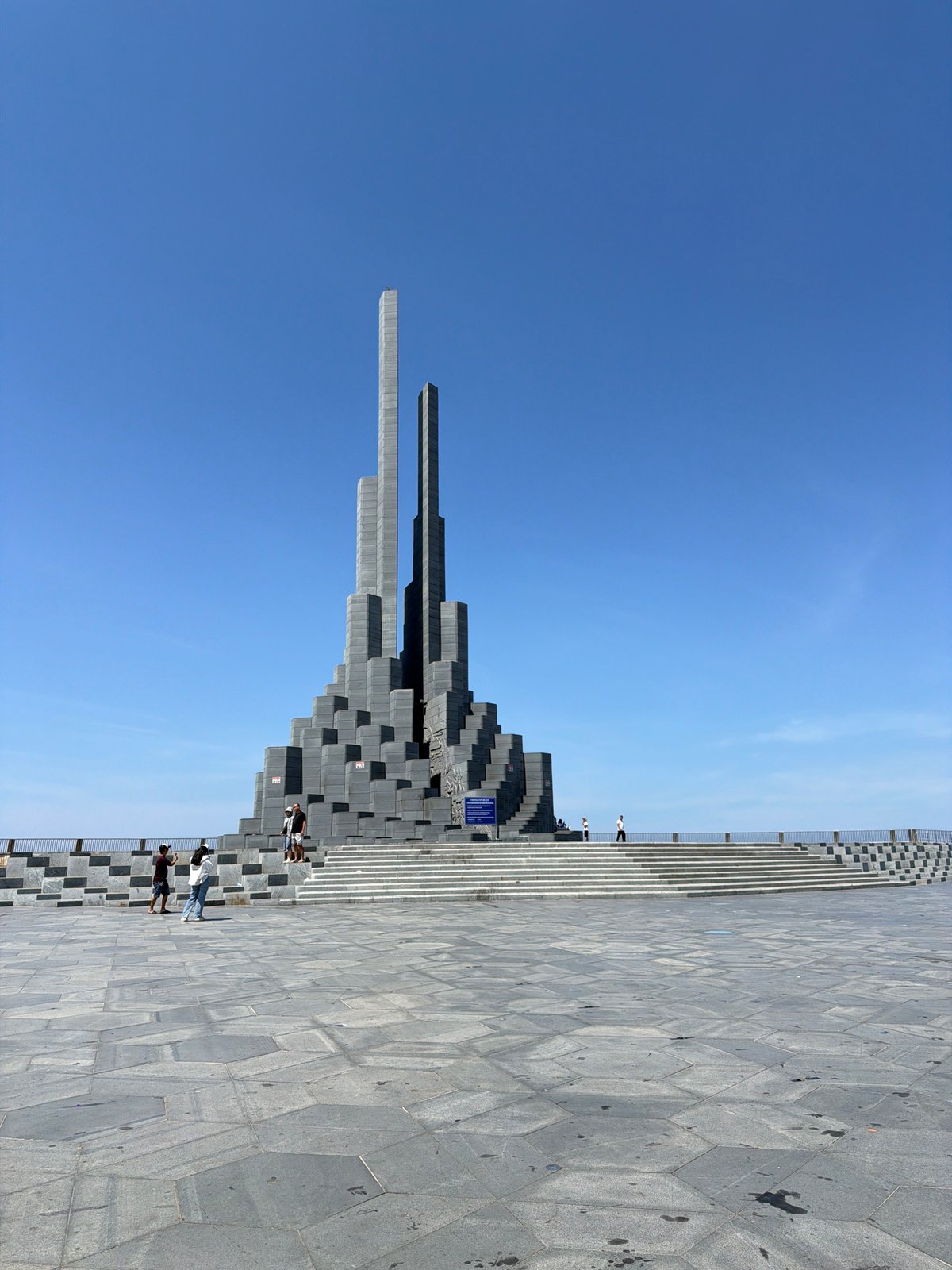 Martyr monument in Tuy Hoa, dark stone rising against blue sky