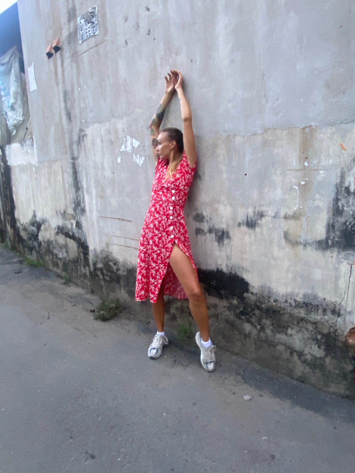 Woman in red dress rests, jogs through Đồng Nai streets
