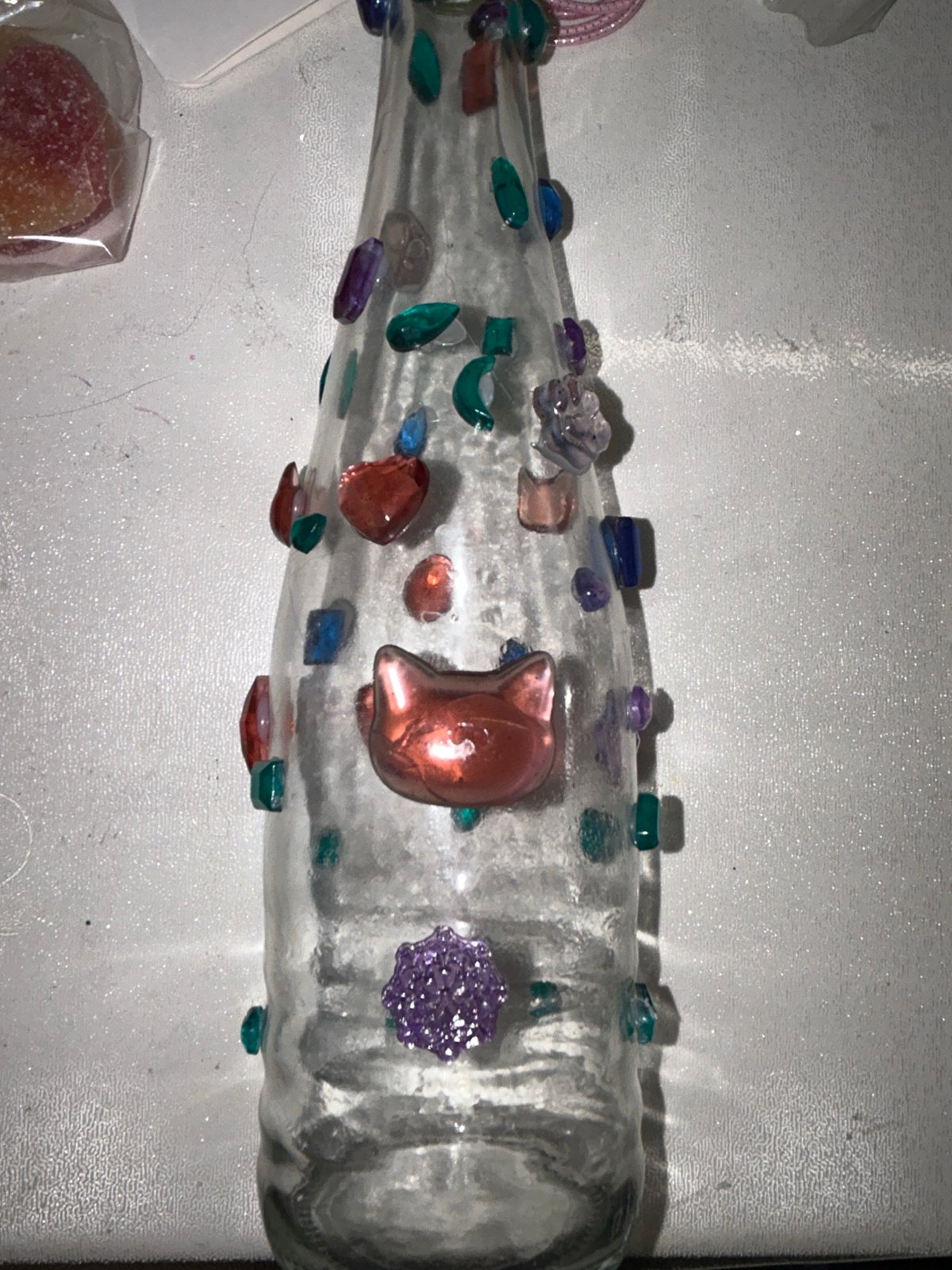 Colorful gems, vials, and hair ties in a crafting spread