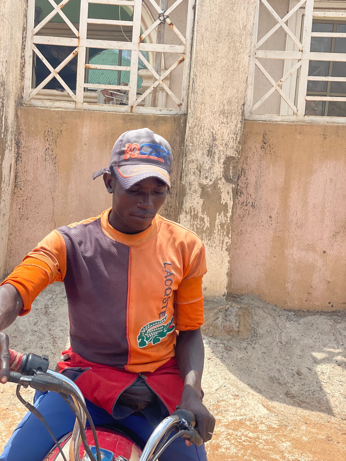 Casual street scene with motorcycle rider observed in Lokoja