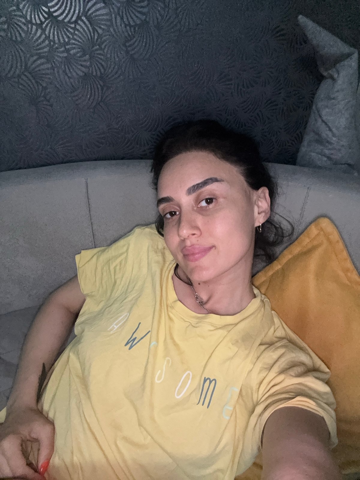 Woman relaxes on sofa in Tbilisi apartment