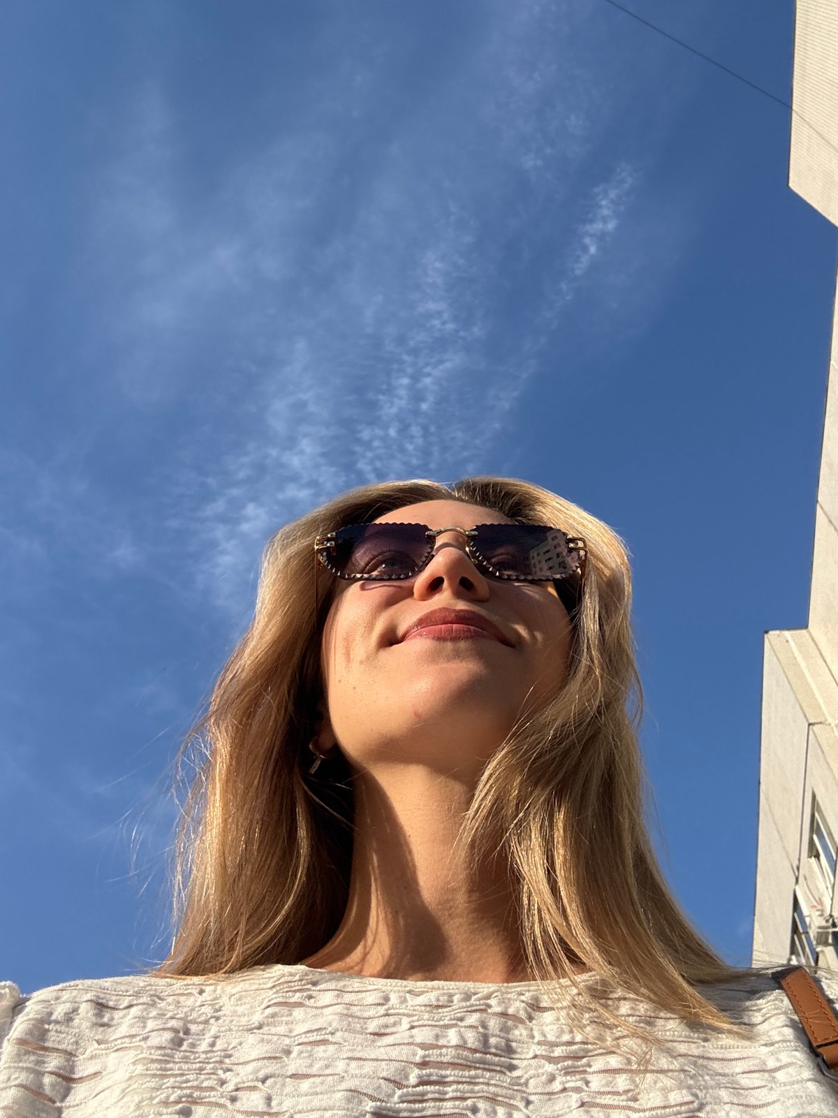 Woman documents urban afternoon with selfies and street walking