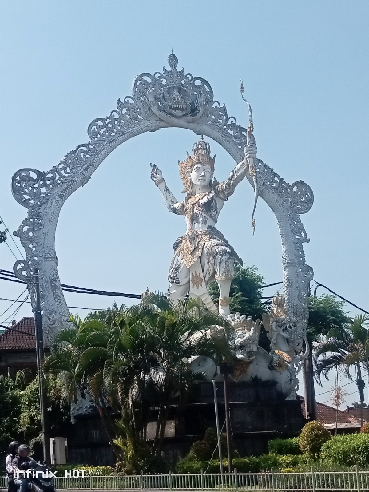 Ornate crowned statue with bow and arrow in Gianyar