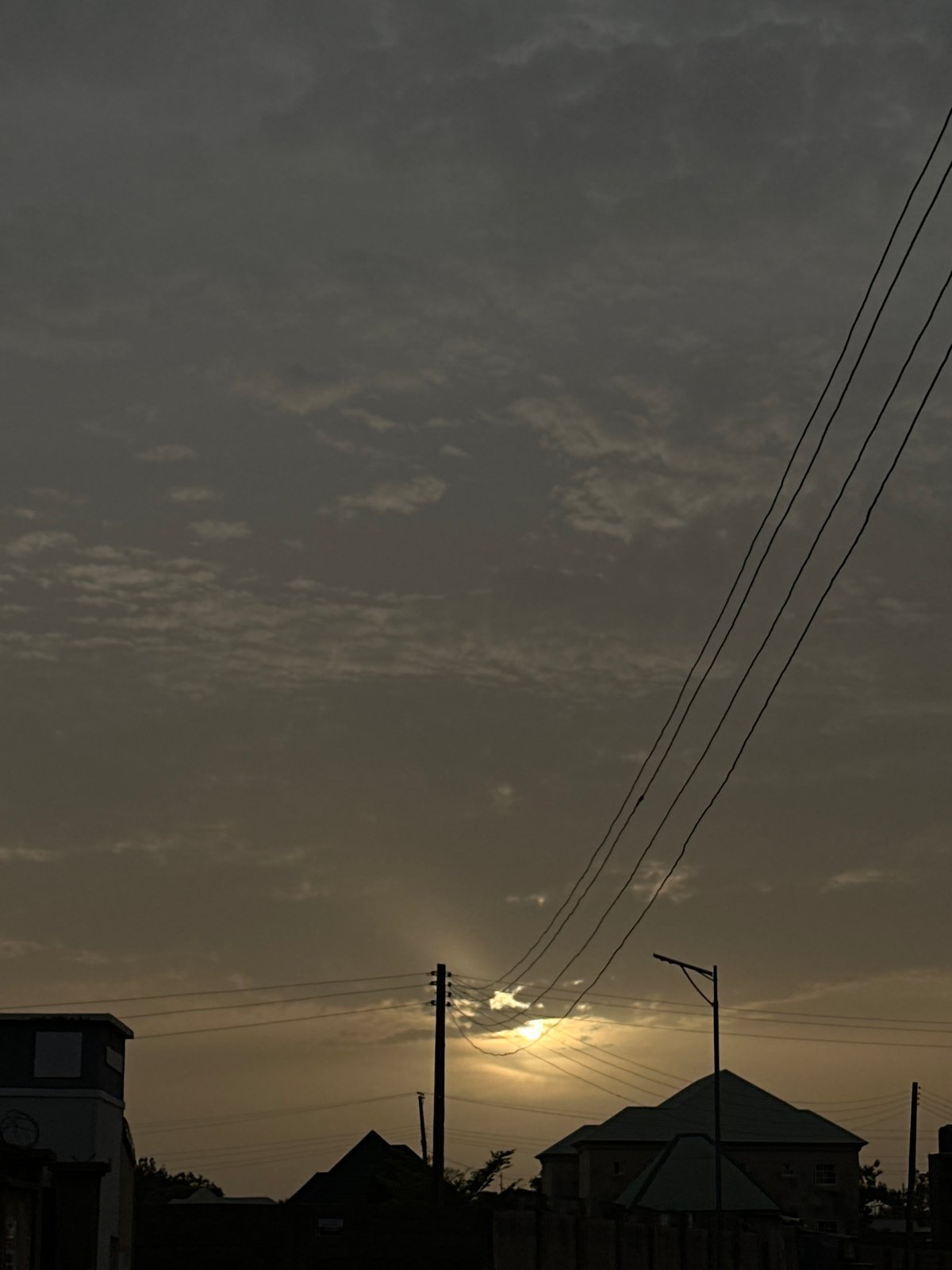 Overcast skies with power lines documented in Kirana, Nigeria