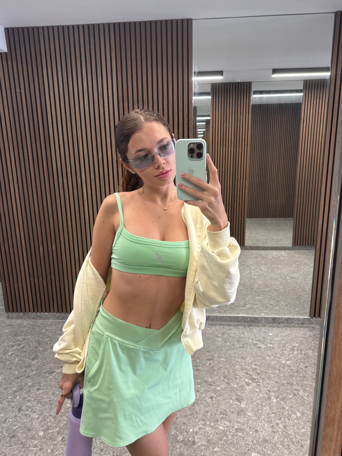 Woman takes mirror selfie at Cyprus gym in athletic wear