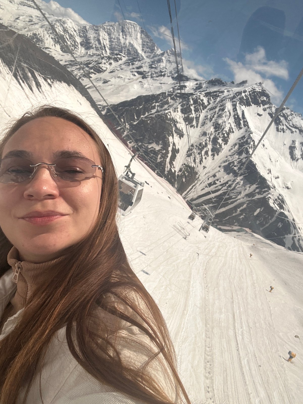 Cable car ascent through snowy mountains in Terskol