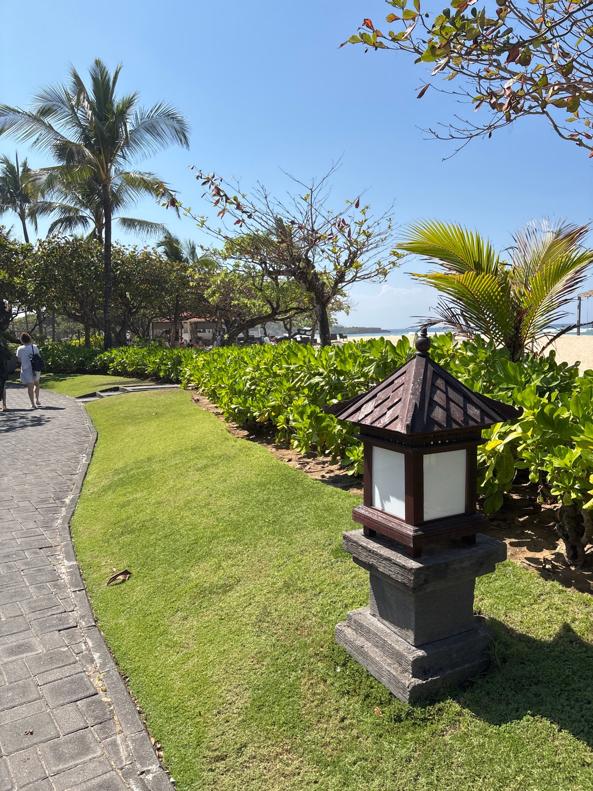 Bali resort grounds and beach on a clear tropical morning