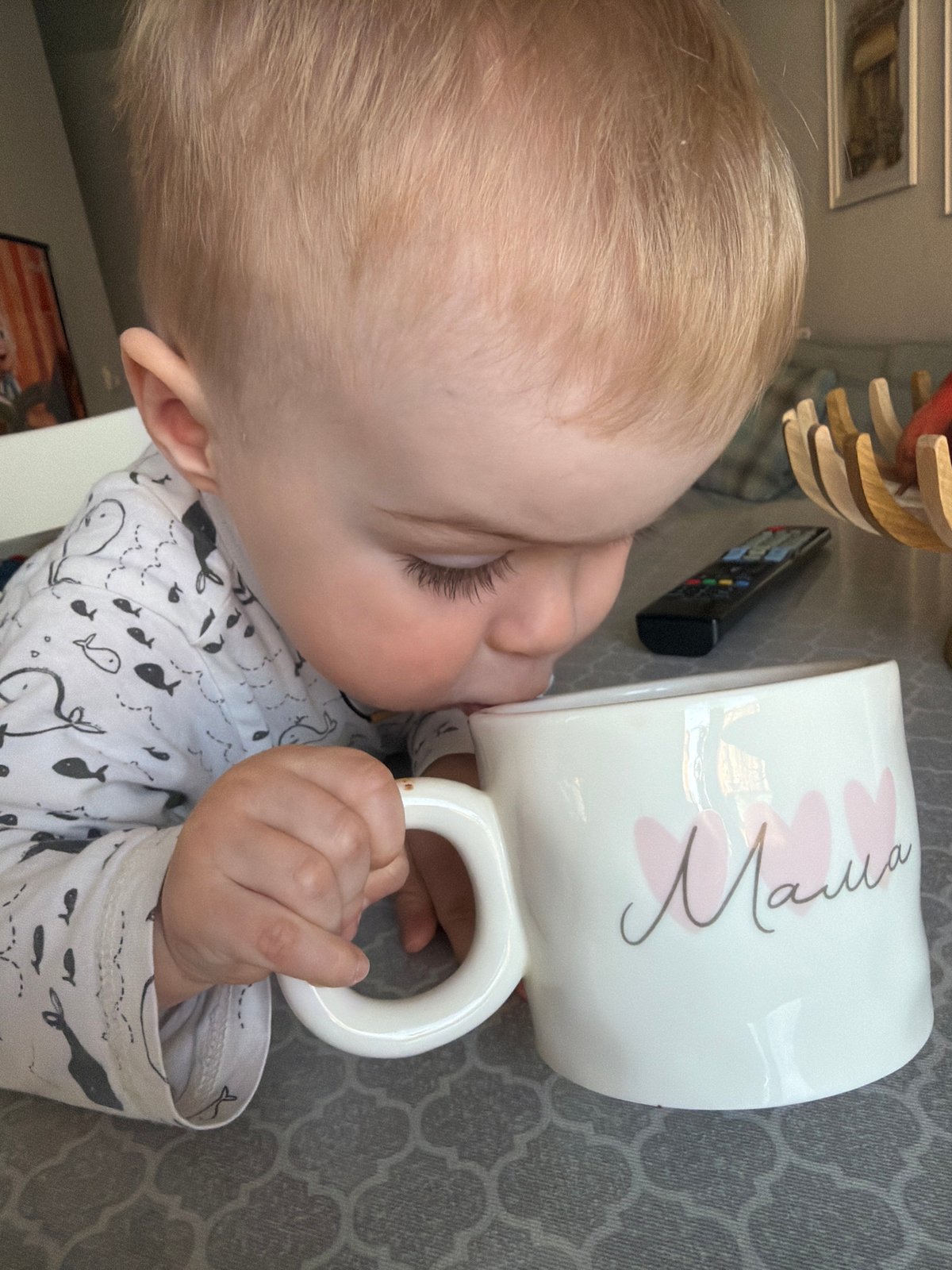 Mother and toddler share morning routine with "Mama" mug