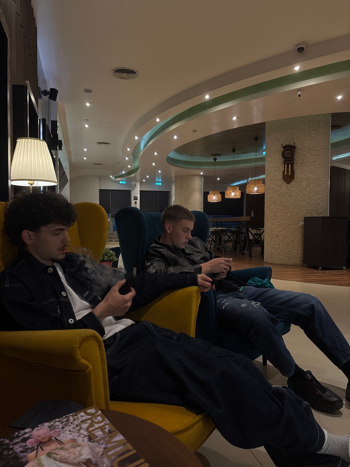 Young men relax in Sofia lounge area evening