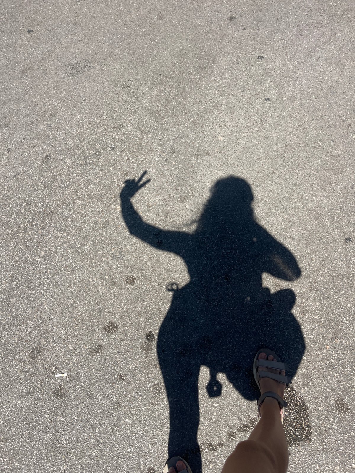 Groceries, a yoga mat, and a peace sign shadow on pavement