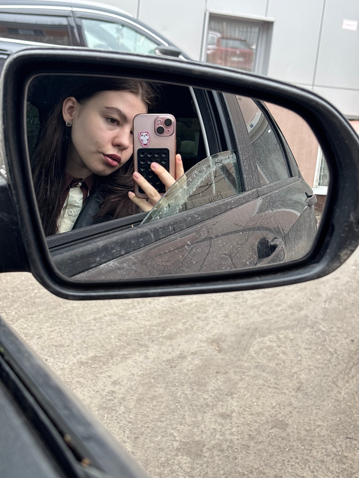 Woman takes selfies in car mirrors in Perm