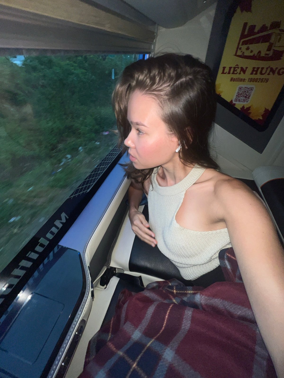 Young woman travels by vehicle through green landscape in Vietnam