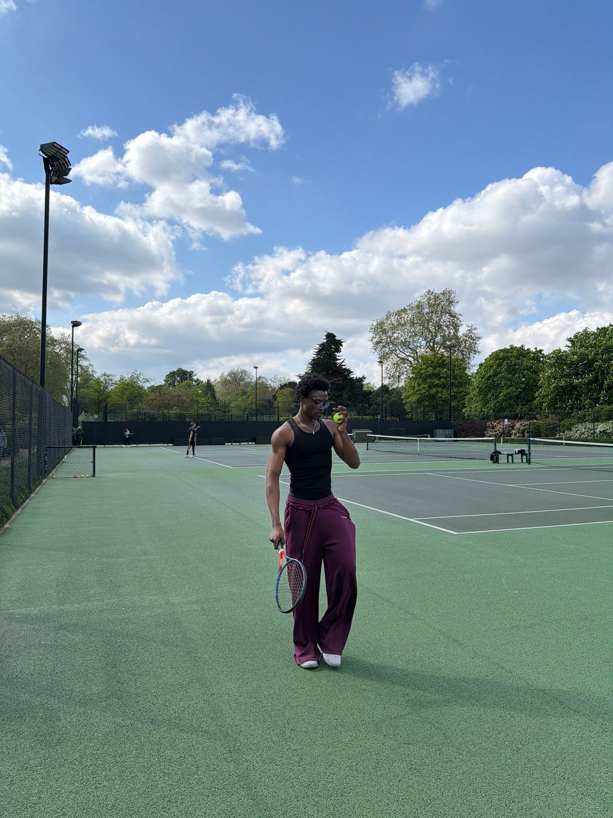 Tennis match in progress at London outdoor court