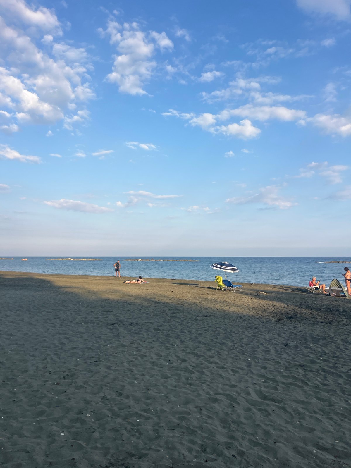 Dark sand beach afternoon on the Cyprus coast