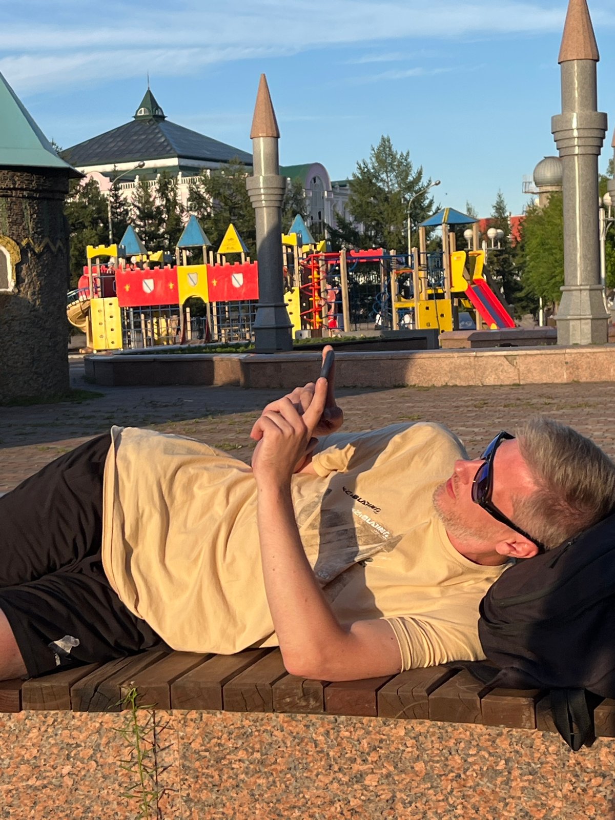 Relaxing on a bench in Krasnoyarsk with a phone