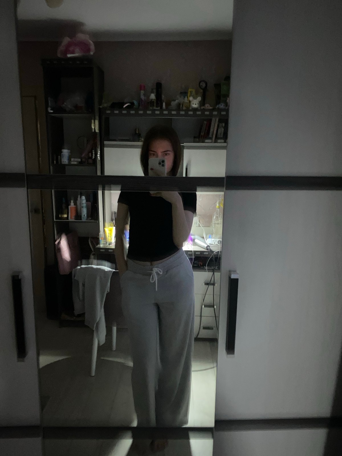Young woman documents bathroom routine in mirror selfies