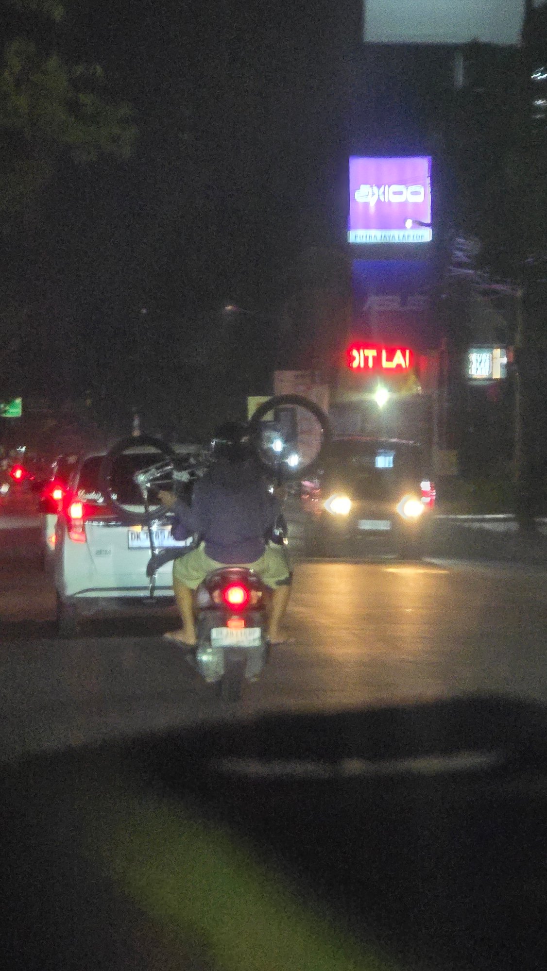 Motorcycle rider spotted on Batubulan street at night